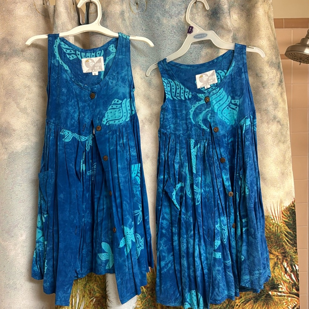 Two cute little blue dresses with little reef, sea shells, and starfish